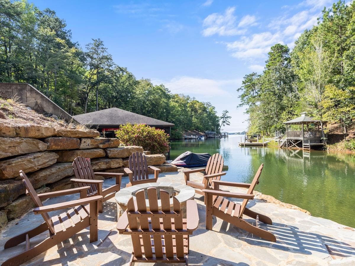 Enjoy sitting next to the fire pit on the flagstone patio by the water. 
